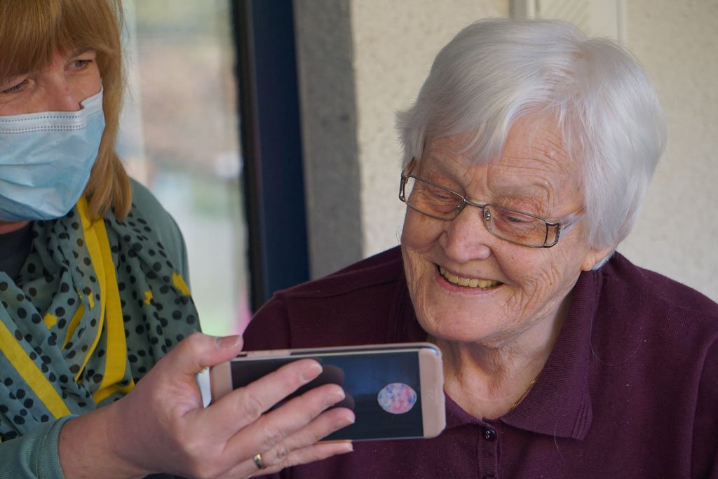 Elderly Women being shown something on phone